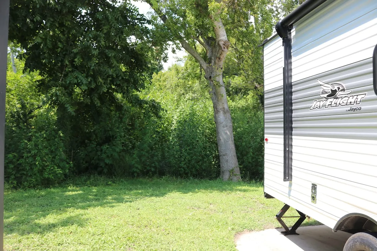 Campcation RV set among campground trees